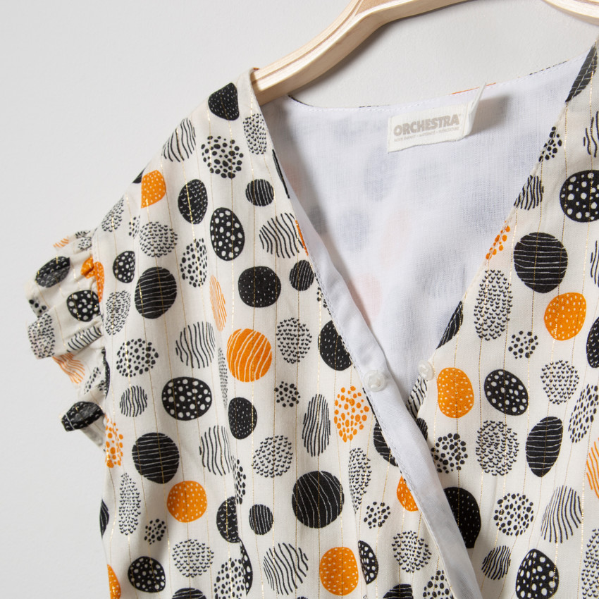 Φόρεμα με κοντό μανίκι και χρωματιστά πουά και χρυσές λεπτομέρειες. 