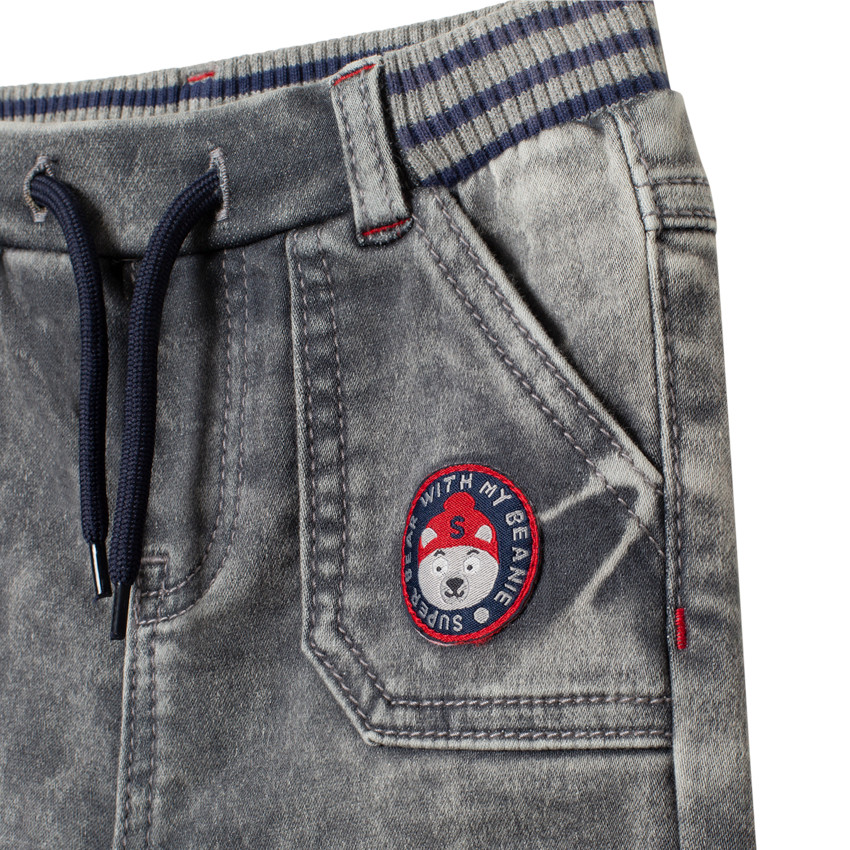 Jean effetused à badge et taille élastiquée 